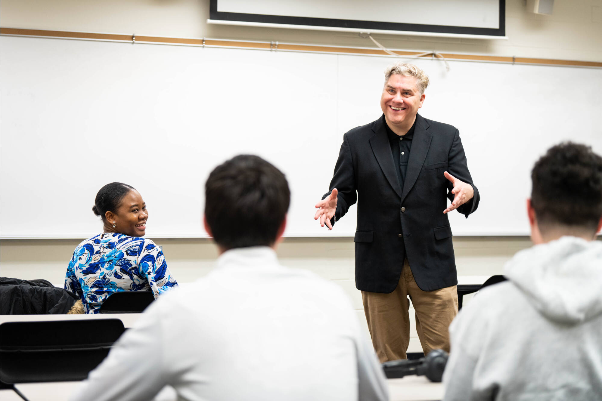 Professor enthusiastically teaching.